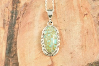 Genuine Number 8 Mine Turquoise Stone set in Sterling Silver Pendant. Free 18" Sterling Silver Chain with Purchase of Pendant. Created by Navajo Artist Larson Lee. Signed by the artist. The Number 8 mine is located in Eureka County Nevada. Since 1976 there has been no Number 8 Turquoise mined. There is however, an existing stock pile that Mr. Dowell Ward, the last owner of the Number 8 mine, had stocked away for later sorting. The Turquoise is a collector's item--because once the reserve is gone there will be no more material released onto the market. The Gold Mining Company owns the claim to the Number 8 mine and it has been swallowed up by the gold mining operations. This is some of the last Number 8 Turquoise to be had and will be a great addition to your collection. 
